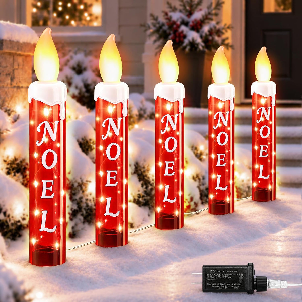 Five red Noel candle stake lights with glowing flames along a walkway